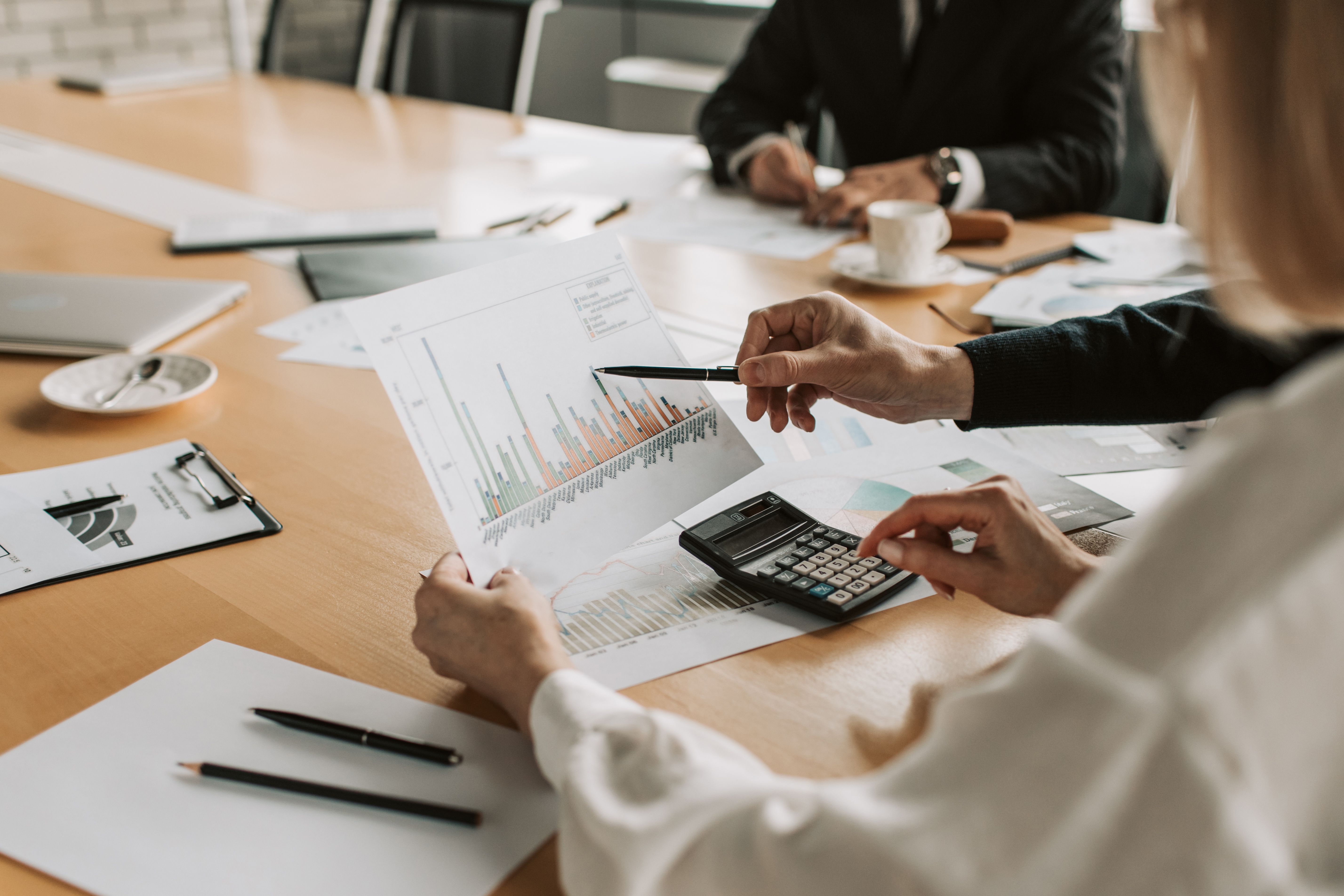 Professionals reviewing financial graphs and charts during a meeting